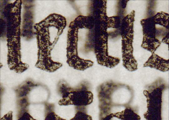 Close up of Gutenberg letters, with light shining through page. [via]